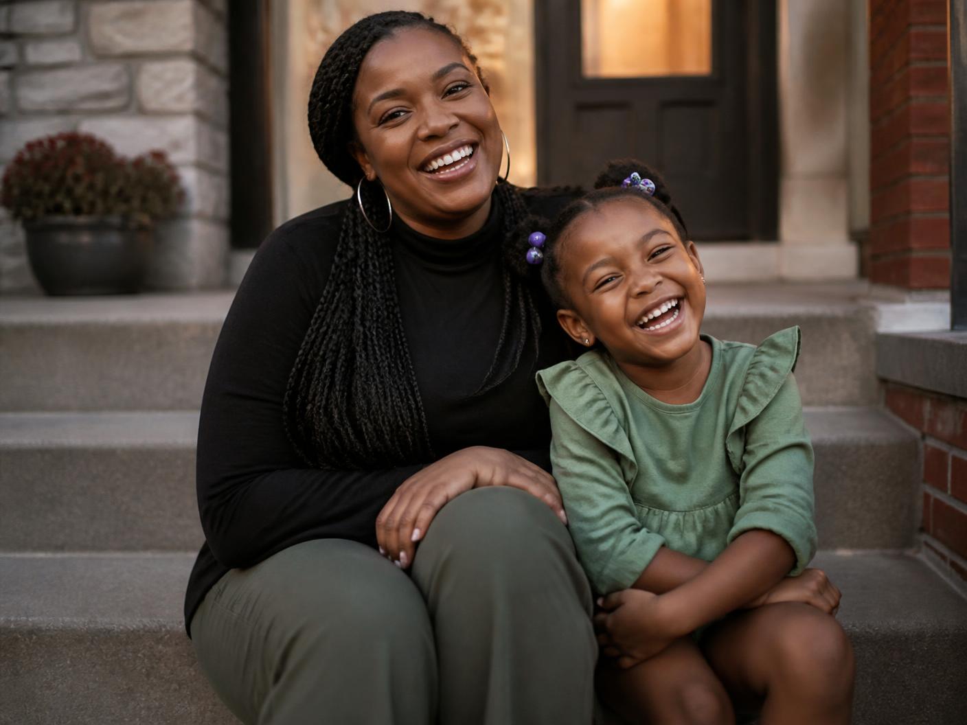 A mother and daughter laughing together at home