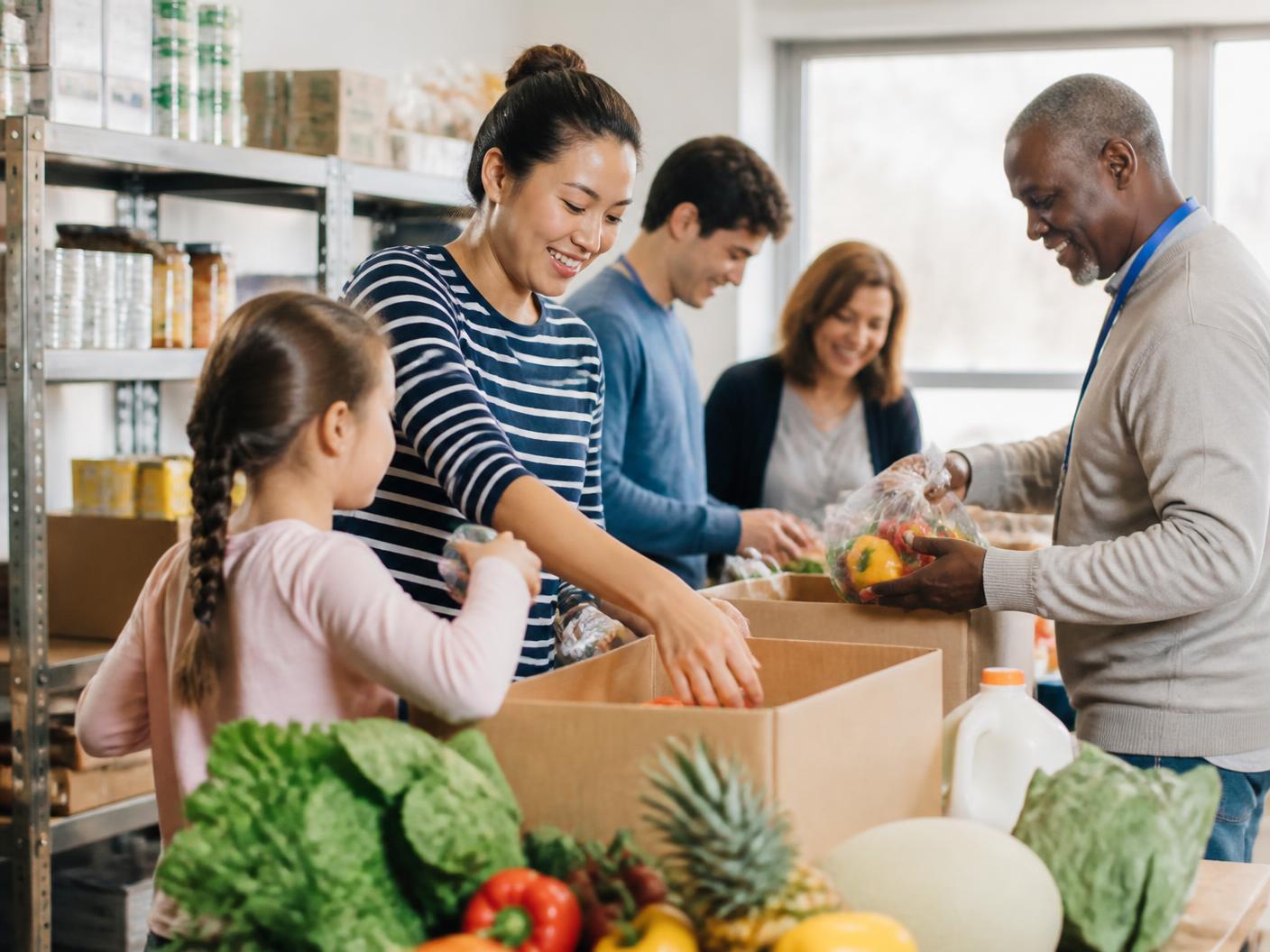 Volunteers packing fresh groceries at a neighborhood pantry